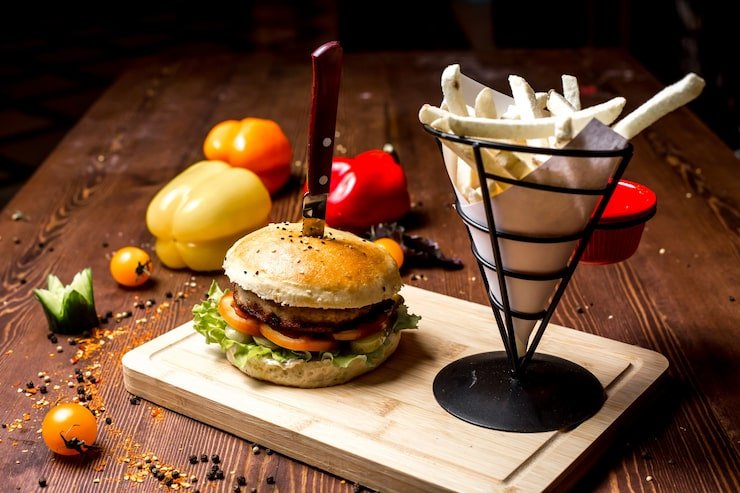 side-view-meat-burger-with-french-fries-board-bell-pepper_141793-4999